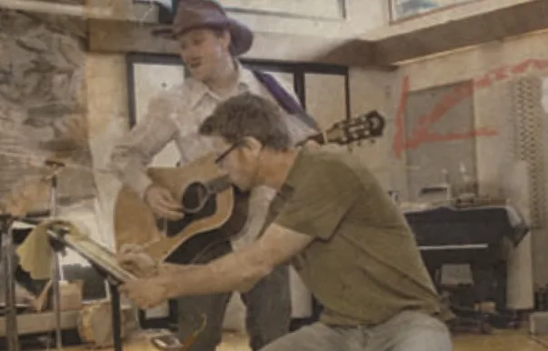 Phil Bunkum and Mark working out a song on acoustic guitars in the studio